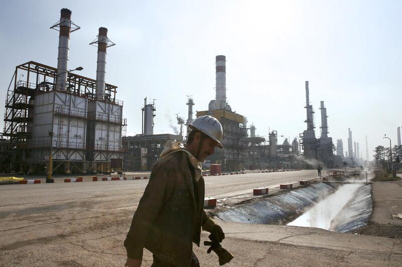 An Iranian oil worker makes his way through Tehran's oil refinery south of the capital Tehran. Iran was the second-largest producer in Opec until sanctions were intensified in 2012. Vahid Salemi / AP Photo