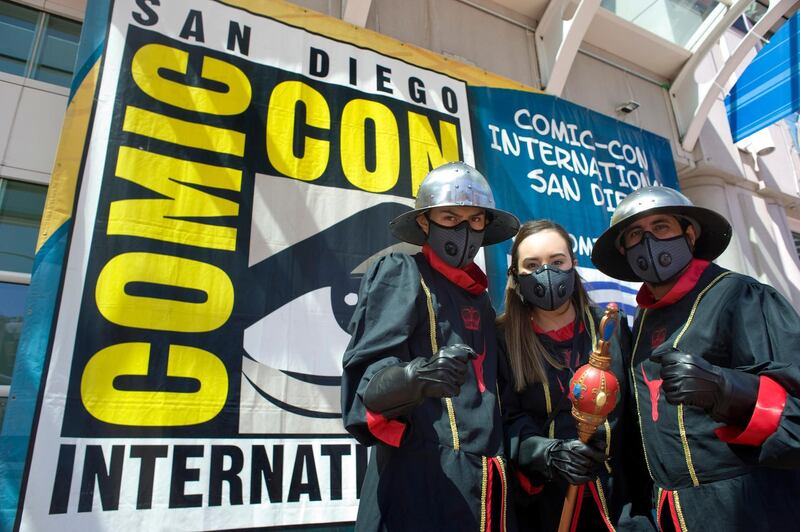 Attendees dressed as characters from the Pennyworth series pose for pictures outside the San Diego Convention Center. EPA