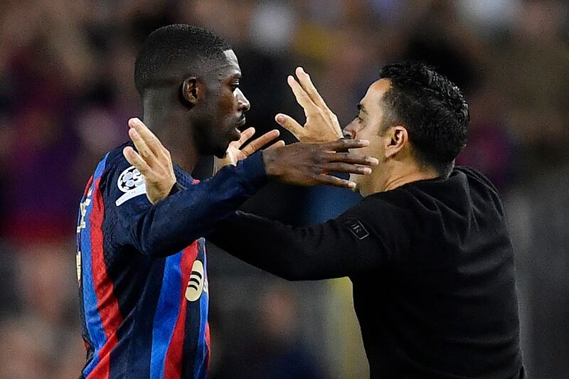 Dembele celebrates with Barcelona coach Xavi. AFP