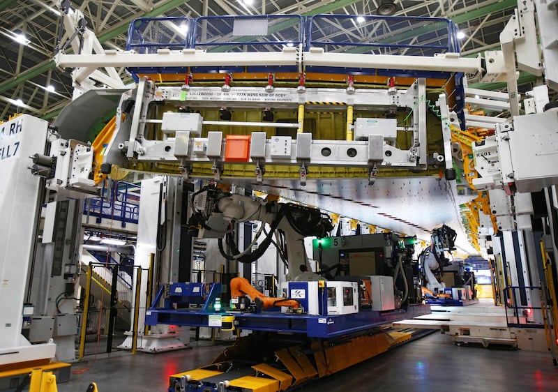 A fixed-bed robot works in a wing assembly station.