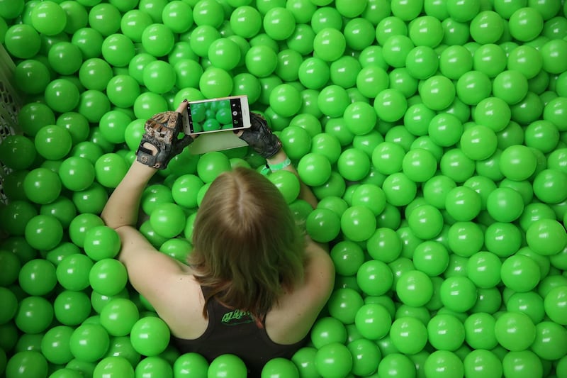 A woman takes a photo in ballpit at the Re:publica 18 conference in Berlin, Germany. Sean Gallup / Getty Images
