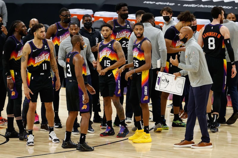 Abdel Nader and his Phoenix Suns teammate listen to head coach Monty Williams talk to the team during a time out against the Denver Nuggets. AFP