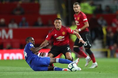 Manchester United's Alexis Sanchez, top falls over after a tackle form Leicester City's Ricardo Pereira during the English Premier League soccer match between Manchester United and Leicester City at Old Trafford, in Manchester, England, Friday, Aug. 10, 2018. (AP Photo/Jon Super)