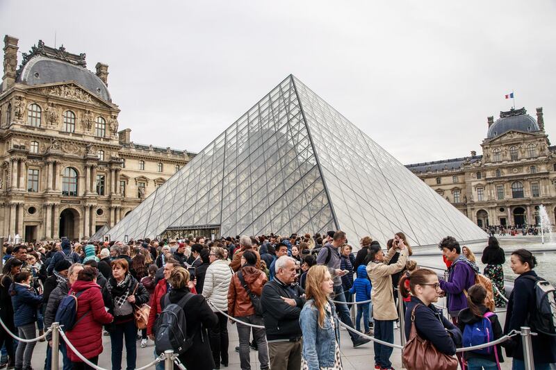 Visitors queue outside the Louvre Museum Pyramid to enter the exhibition of the Italian Renaissance artist Leonardo Da Vinci in Paris.  EPA