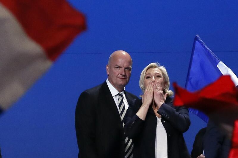 French far-right presidential candidate Marine Le Pen, flanked by her body guard Thierry Legier, blows kisses to supporters at the end of a rally in Villepinte, outside Paris, on May 1, 2017. Francois Mori / AP Photo