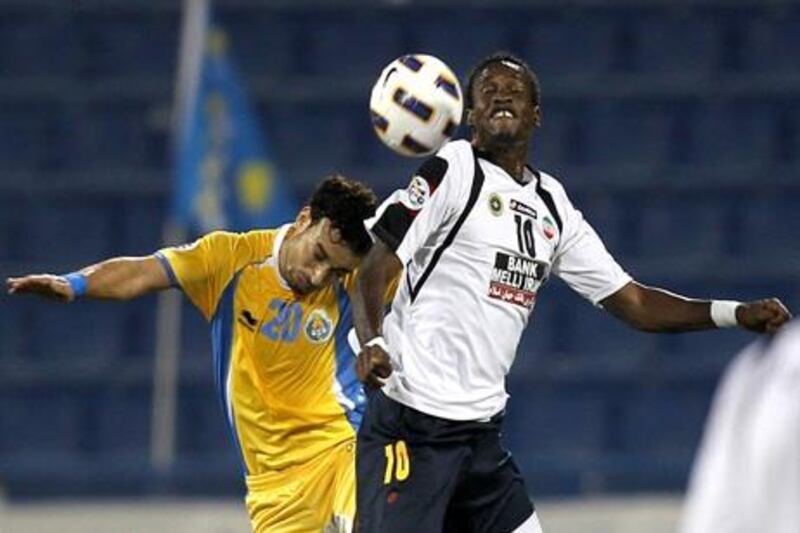 Othman al-Assas of Qatar's Al-Gharrafa (L) challenges Ibrahima Toure of Iran's Sepahan during their AFC Champions League group A football match at Al-Gharrafa Stadium in Doha on April 20, 2011. AFP PHOTO/KARIM JAAFAR