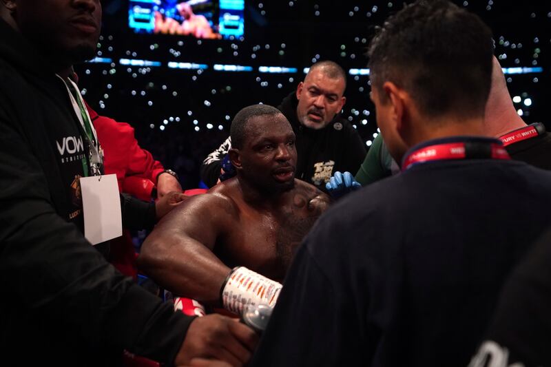 Dillian Whyte is surrounded by his team after his defeat to Tyson Fury at Wembley Stadium. PA