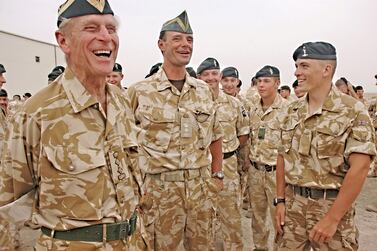 Britain's Duke of Edinburgh, Prince Philip (L), in his role as the Regiment?s Colonel in Chief, is seen visiting The Queen?s Royal Hussars in Basra in this handout photograph released on October 22, 2006, by the Ministry of Defence. Prince Philip told the troops he thought most people in Britain had "a great deal of sympathy for those of you at the sharp end who are trying to do your best to make life civilized and tolerable for the locals." EDITORIAL USE ONLY. QUALITY FROM SOURCE. REUTERS/Ministry of Defence/Handout (IRAQ)