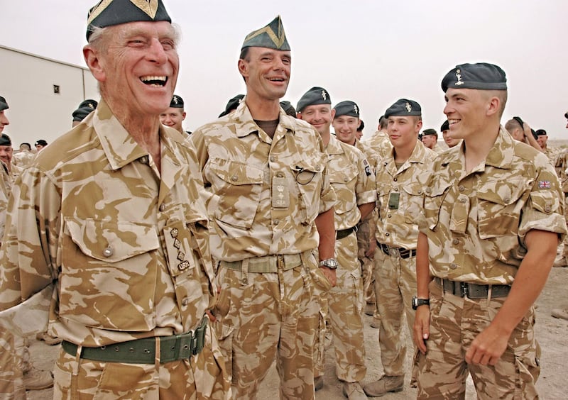 Britain's Duke of Edinburgh, Prince Philip (L), in his role as the Regiment?s Colonel in Chief, is seen visiting The Queen?s Royal Hussars in Basra in this handout photograph released on October 22, 2006, by the Ministry of Defence. Prince Philip told the troops he thought most people in Britain had "a great deal of sympathy for those of you at the sharp end who are trying to do your best to make life civilized and tolerable for the locals." EDITORIAL USE ONLY. QUALITY FROM SOURCE. REUTERS/Ministry of Defence/Handout (IRAQ)