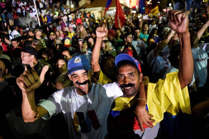 Supporters of the Venezuelan President Nicolas Maduro celebrate after the National Electoral Council announced the results of the voting on presidential election in Caracas, Venezuela. Federico Parra / AFP