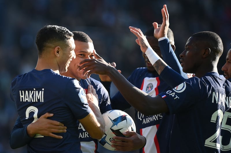 Paris Saint-Germain defender Achraf Hakimi celebrates with teammates after scoring the third goal. AFP