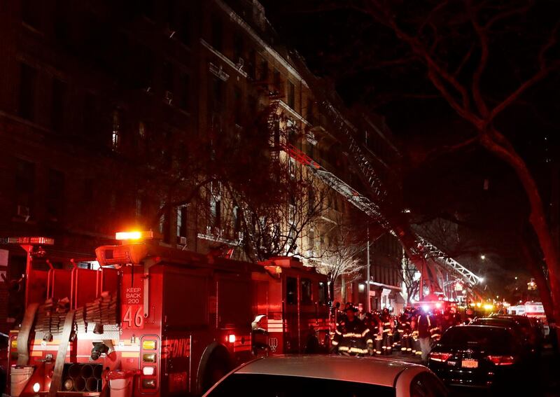 Firefighters respond to a building fire that killed at least 12 people in the Bronx borough of New York on December 28, 2017. Four survivors were in critical condition. Frank Franklin II / AP Photo