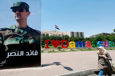 A poster of Bashar Al Assad in Damascus that reads "leader of the triumph". AFP 