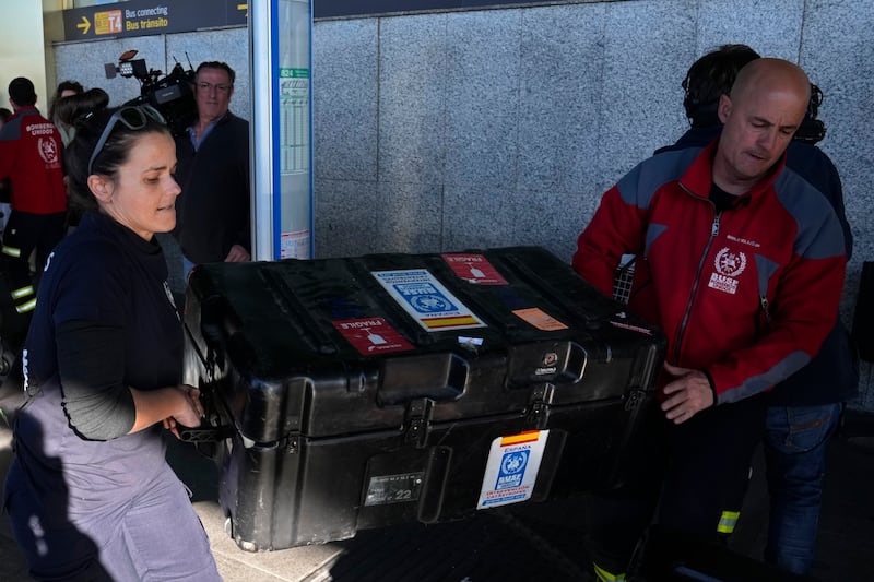 Spanish firefighters with their equipment at Barajas international airport in Madrid, Spain. AP