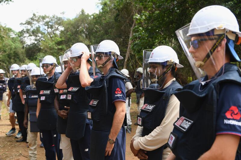 England players, from left to right, Jonny Bairstow, Keaton Jennings, Joe Root and Olly Stone fitted out with de-mining personal protective equipment listen to a briefing before a tour of a previously cleared area of mine in Periyamadu. Getty Images