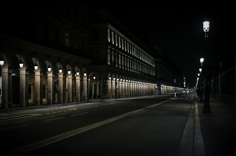 An empty street at night in Paris, as a strict lockdown came into effect in France to stop the spread of Covid-19. AFP