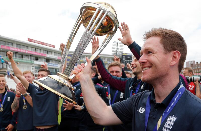 England's Eoin Morgan, right, and teammates celebrate with the trophy at the Oval in London,  one day after they won the Cricket World Cup in a final match against New Zealand. AP Photo