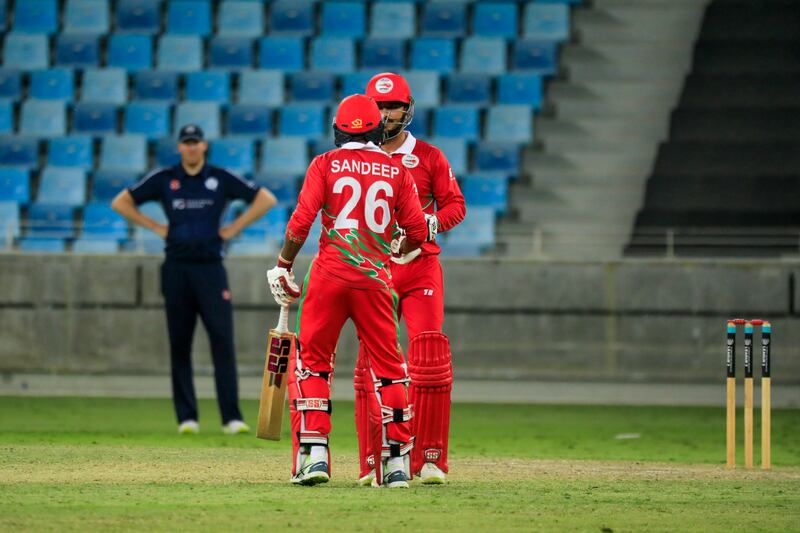Oman batters in discussion during the game against Scotland. Photo: ICC