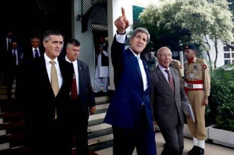 US secretary of state John Kerry leaves a press conference with Pakistan's foreign affairs advisor Sartaj Aziz, right, in Islamabad.