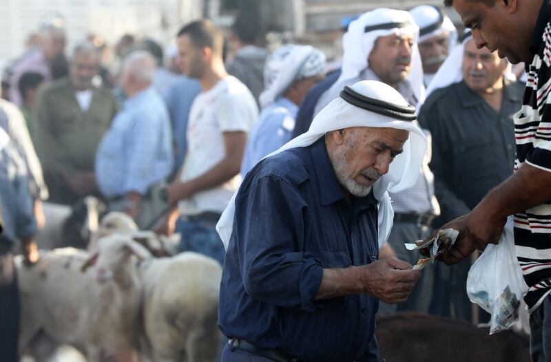 epa06167936 Palestinian vendors sell Sacrificial animals at a livestock market ahead of Eid al-Adha, in the West Bank town of Nablus, 28 August 2017. Eid al-Adha is the holiest of the two Muslims holidays celebrated each year, it marks the yearly Muslim pilgrimage (Hajj) to visit Mecca, the holiest place in Islam. Muslims slaughter a sacrificial animal and split the meat into three parts, one for the family, one for friends and relatives, and one for the poor and needy.  EPA/ALAA BADARNEH