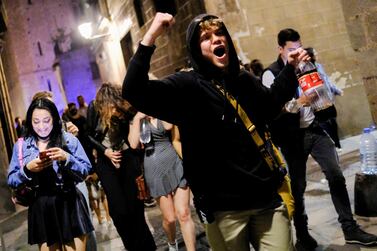 People celebrate on a street in the neighborhood of Born, Barcelona, as the state of emergency decreed by the Spanish Government to prevent the spread of the coronavirus disease gis lifted in Spain, May 9, 2021. Reuters