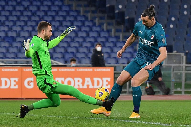 AC Milan's Swedish forward Zlatan Ibrahimovic challenges Roma's Spanish goalkeeper Pau Lopez. AFP