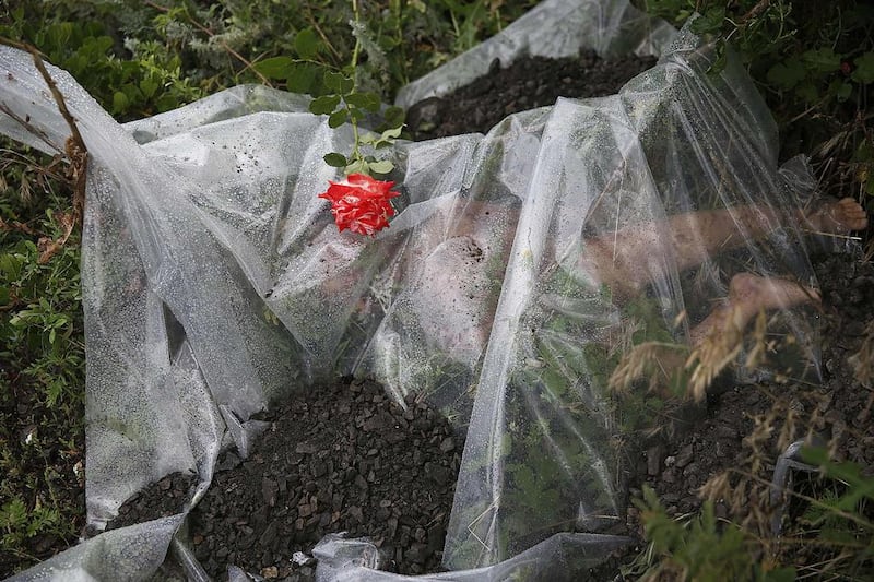 A rose lies on a plastic sheet covering a victim of a Malaysian Airlines plane which was downed on Thursday near the village of Rozsypne, in the Donetsk region of Ukraine. Maxim Zmeyev / Reuters / July 18, 2014