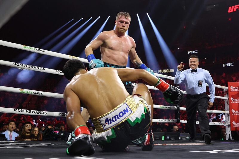 Saul 'Canelo' Alvarez knocks down Jaime Munguia during their super-middleweight title fight at T-Mobile Arena in Las Vegas on May 4, 2024. The judges scored it 117-110, 116-111 and 115-112 for Alvarez, who retained his IBF, WBA, WBC and WBO belts. AFP