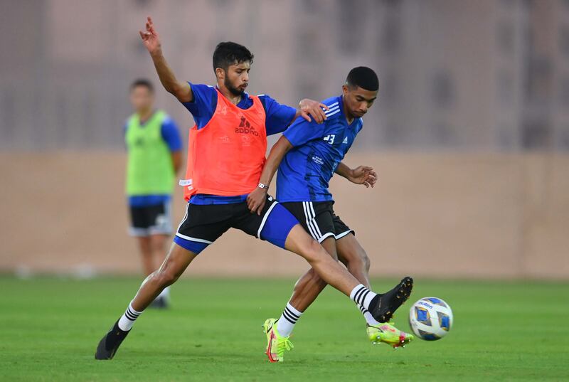 Mohammed Al Attas tackles Mohammed Juma during a UAE training session.