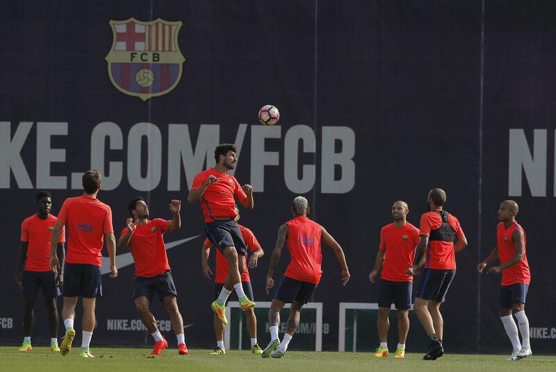 Barcelona midfielder Andre Gomes, centre, heads the ball during a training session at the Sports Center FC Barcelona Joan Gamper in Sant Joan Despi, Spain. Manu Fernandez / AP Photo