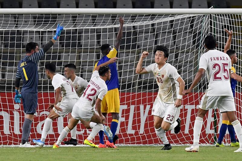 Al Wahda players celebrate after scoring a goal. AFP