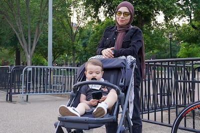 Isra Chaker and her 18-month old son Sameer attend a candlelight vigil outside the White House honouring Shireen Abu Akleh. Willy Lowry / The National