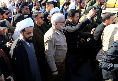 Qais al-Khazali, leader of the militant group Asaib Ahl al-Haq, and Abu Mahdi al-Muhandis, a commander in the Popular Mobilization Forces attend a funeral procession of the members of Hashd al-Shaabi (paramilitary forces), who were killed by U.S. air strikes in Qaim district western country, in Green zone in Baghdad, Iraq December 31, 2019. REUTERS/Thaier al-Sudani