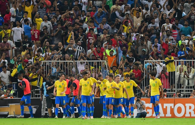 Brazil players celebrate with Miranda after he scores the decisive goal of the game against Argentina. Reuters