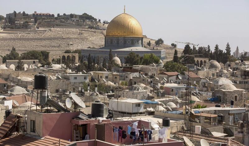 The Dome of the Rock, in the old city of Jerusalem, and the ancient Jewish cemetery on Mount of Olives in the background. Unesco passed a resolution that denies the Jewish link to the Temple Mount and the Western Wall.  Atef Safadi / EPA