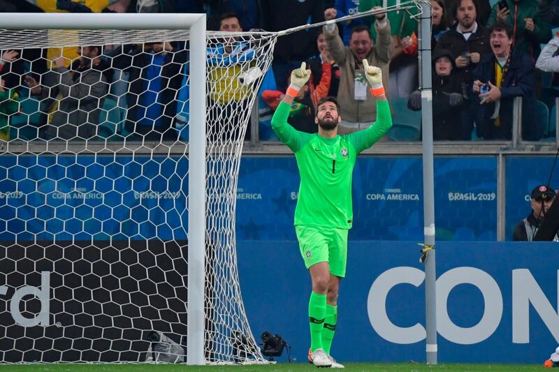 Alisson celebrates after stopping the shot by Paraguay's Gustavo Gomez in the penalty shoot-out. AFP