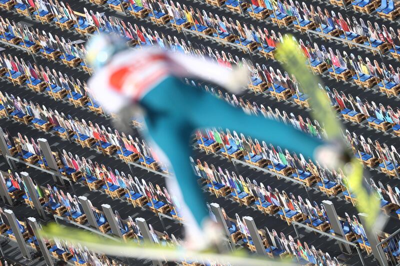 Cardboard spectators form a colourful backdrop as Finland's Jarkko Maatta jumps during ski jumping training in Oberstdorf, Germany. Reuters