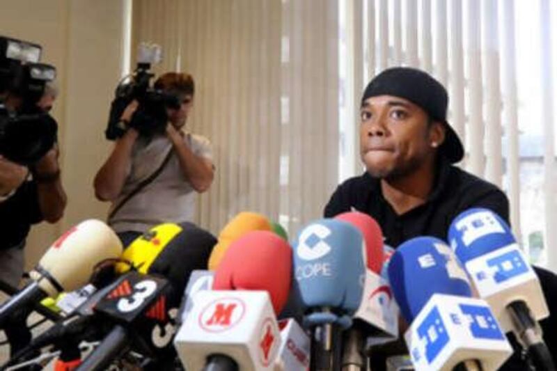 Real Madrid's Brazilian player Robinho attends a press conference on August 31, 2008 in Madrid. Robinho said that his "head was at Chelsea" and that he was determined to leave the Spanish club despite efforts of team bosses to keep him. I've already told the president (Ramon Calderon), and coach (Bernd Schuster), management and (the media): my head is there (at Chelsea), I want to play over there," the 24-year-old said. AFP PHOTO/ Dani POZO *** Local Caption ***  203278-01-08.jpg