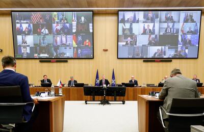 NATO Secretary General Jens Stoltenberg, center, speaks during a video conference of NATO Defense Minister at the NATO headquarters in Brussels, Wednesday, June 17, 2020. NATO Defense Ministers began two days of video talks focused on deterring Russian aggression and a US decision to withdraw thousands of troops from Germany. (Francois Lenoir, Pool Photo via AP)