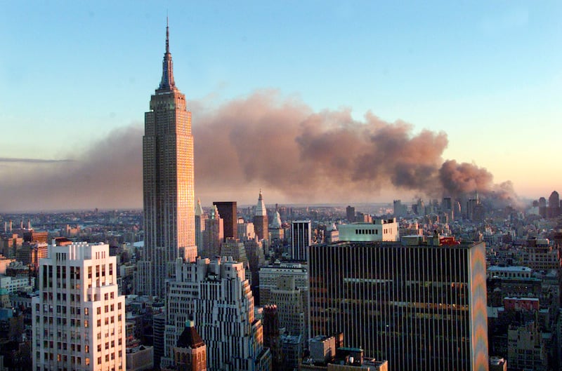 Smoke pours from the site and drifts across the New York sky. Reuters