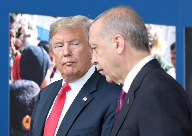 FILE PHOTO: US President Donald Trump (L) talks to Turkey’s President Recep Tayyip Erdogan (R) at NATO headquarters in Brussels, Belgium, 11 July 2018. NATO countries' heads of states and governments gather in Brussels for a two-day meeting. /Pool via REUTERS -/File Photo