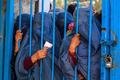 Internally displaced Afghans wait for food aid distributed by a German organisation in Kabul in October. EPA