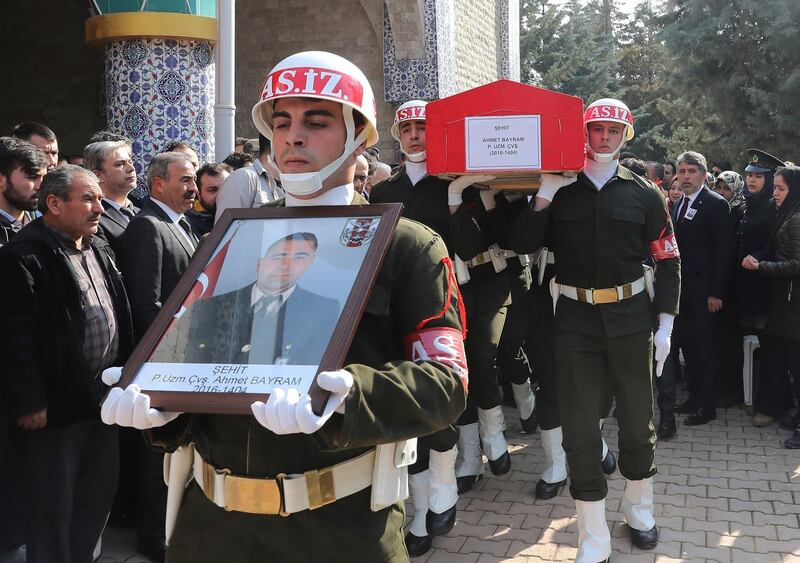 Soldiers carry the coffing of Ahmet Bayram, one of seven Turkish soldiers killed on Saturday in fighting against Syrian Kurdish militiamen, during a funeral ceremony in Hatay, Turkey, Sunday, Feb. 4, 2018. The military says Saturday's deaths were related to Turkey's operation against the Syrian Kurdish-held enclave of Afrin, codenamed Olive Branch. (Pool Photo via AP)