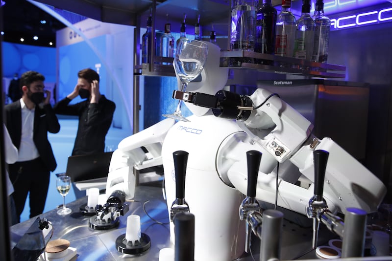 A robot bartender serves drinks at the Telefonica stand. EPA