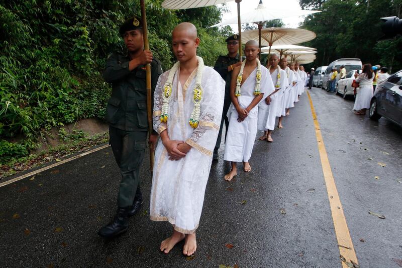 Chanthawong, front, and members of the football team attend a Buddhist ceremony. AP Photo