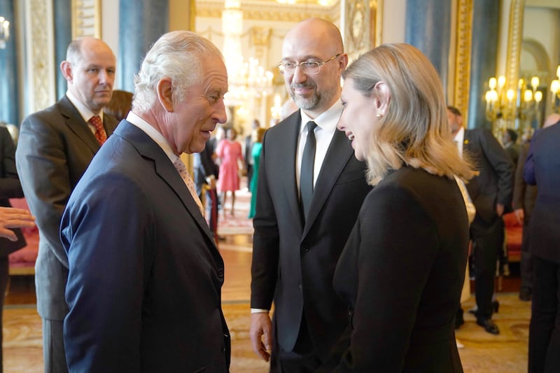 Britain's King Charles III, left, speaks to the First Lady of Ukraine Olena Zelenska and the Prime Minister of Ukraine, Denys Shmyhal, during the reception. AP