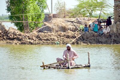 A man uses a makeshift raft to cross a flood waters in Jaffarabad, in Pakistan's Balochistan province. AFP