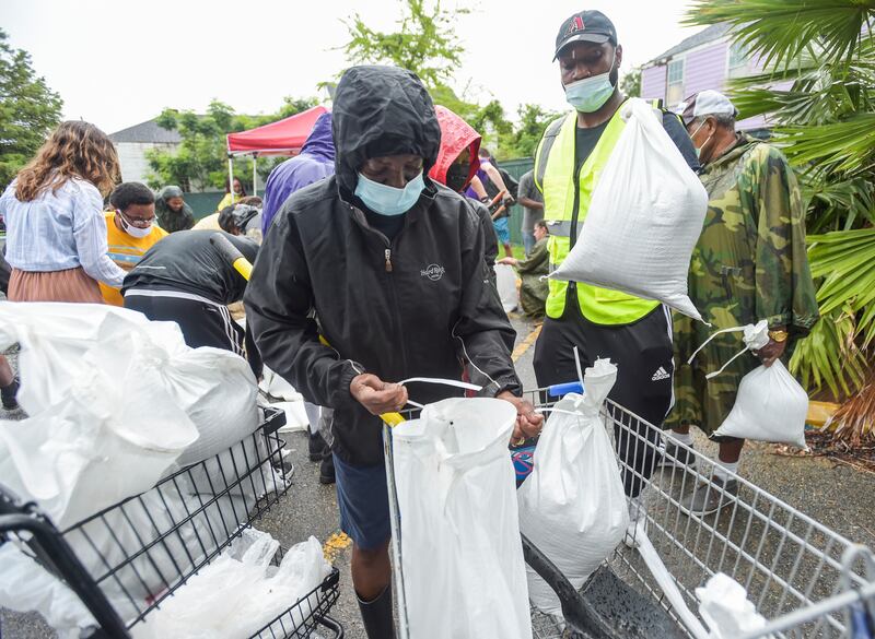 People pick up sandbags at a city run sandbag distribution location in New Orleans as residents prepare for Hurricane Ida. AP