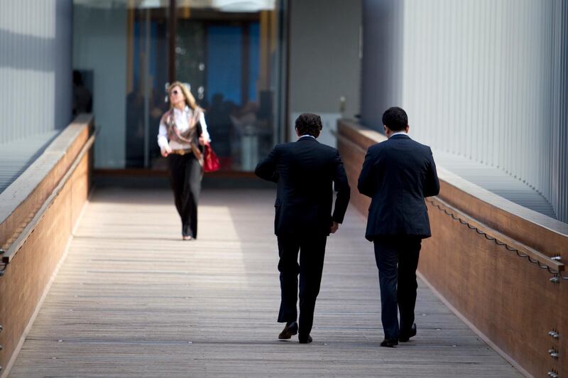 Dubai, Jan 16th, 2012 --  DIFC STOCK -  Businessmen and a businesswoman walk across a bridge in DIFC. Photo by: Sarah Dea/ The National