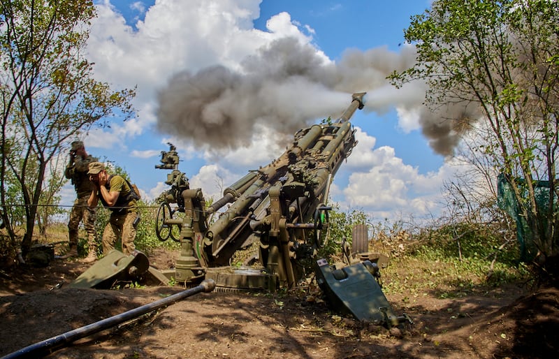Ukrainian servicemen fire an American-made 155mm M777 howitzer in July 2022 in the Kharkiv area. EPA
